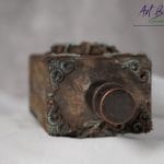 Detal artystycznej karafki fantasy – relief z gliny czaszka w koronie, efekt rdzy i patyny ArtBasia